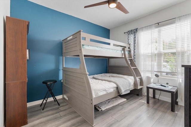 3313 SW Ludlow St, Port Saint Lucie, FL 34953 - bedroom with wood finished floors, baseboards, and ceiling fan