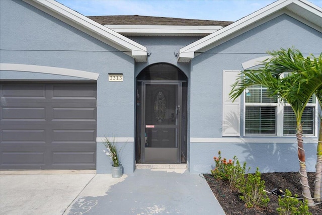 3313 SW Ludlow St, Port Saint Lucie, FL 34953 - doorway to property with a garage, stucco siding, and driveway