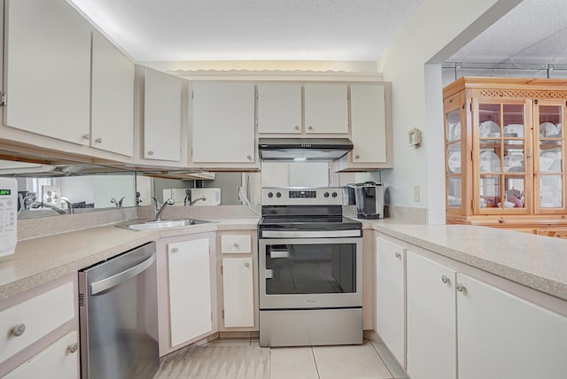 331 Knotty Pine Cir Unit C-1, Greenacres, FL 33463 - kitchen featuring appliances with stainless steel finishes, under cabinet range hood, a sink, light countertops, and light tile patterned flooring