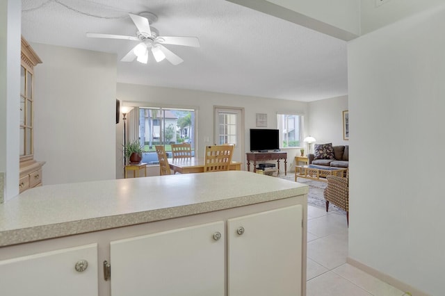 331 Knotty Pine Cir Unit C-1, Greenacres, FL 33463 - kitchen featuring light countertops, light tile patterned flooring, a ceiling fan, a peninsula, and a textured ceiling