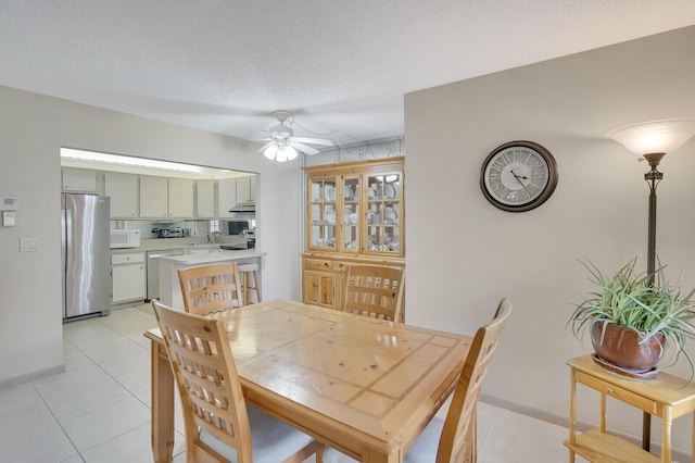 331 Knotty Pine Cir Unit C-1, Greenacres, FL 33463 - dining area featuring light tile patterned floors, ceiling fan, baseboards, and a textured ceiling