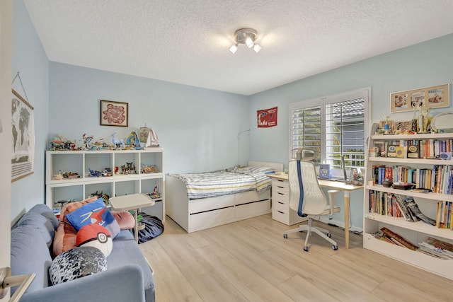 2703 SW Glenmoor Way, Palm City, FL 34990 - bedroom featuring wood finished floors and a textured ceiling