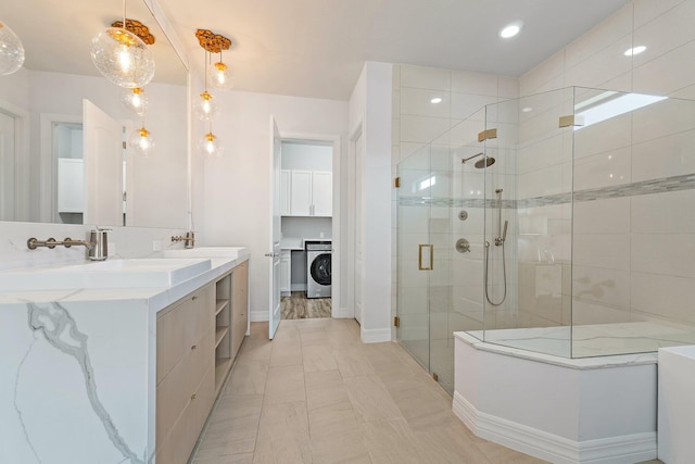 515 Sonoma Isles Cir, Jupiter, FL 33478 - full bathroom with washer / clothes dryer, a shower stall, double vanity, and baseboards