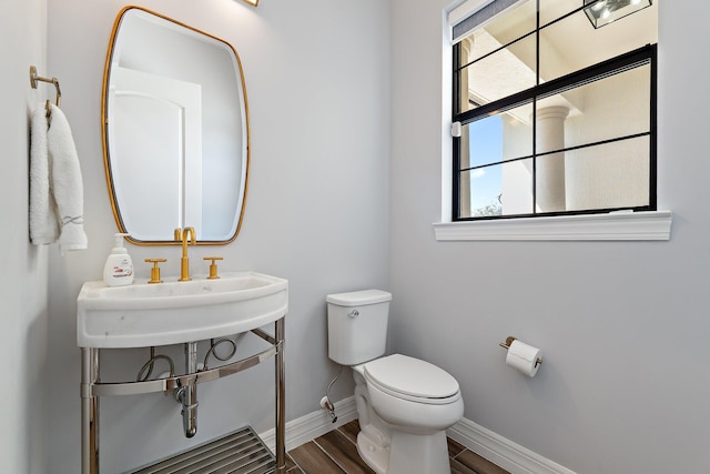 515 Sonoma Isles Cir, Jupiter, FL 33478 - bathroom featuring toilet, baseboards, wood finished floors, and a sink
