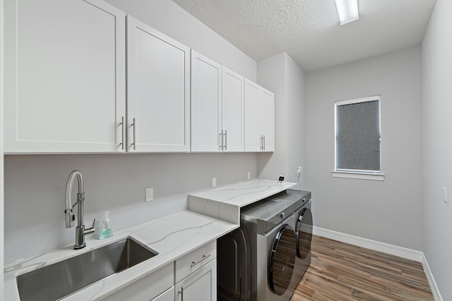515 Sonoma Isles Cir, Jupiter, FL 33478 - laundry area with cabinet space, wood finished floors, baseboards, washer and dryer, and a textured ceiling