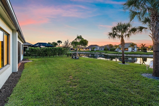 515 Sonoma Isles Cir, Jupiter, FL 33478 - yard at dusk featuring a water view