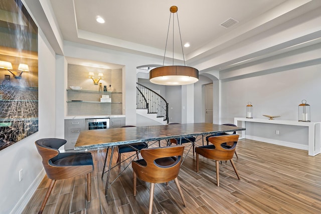 515 Sonoma Isles Cir, Jupiter, FL 33478 - dining area with wood finished floors, baseboards, a tray ceiling, stairs, and recessed lighting