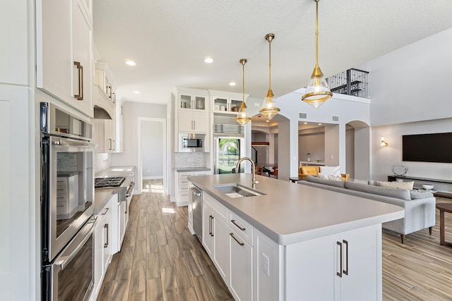 515 Sonoma Isles Cir, Jupiter, FL 33478 - kitchen with a sink, stainless steel appliances, wood finished floors, open floor plan, and recessed lighting