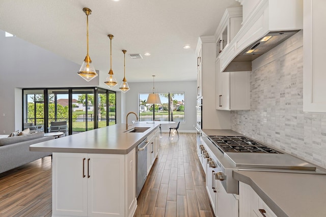 515 Sonoma Isles Cir, Jupiter, FL 33478 - kitchen with custom exhaust hood, a sink, dark wood finished floors, appliances with stainless steel finishes, and recessed lighting