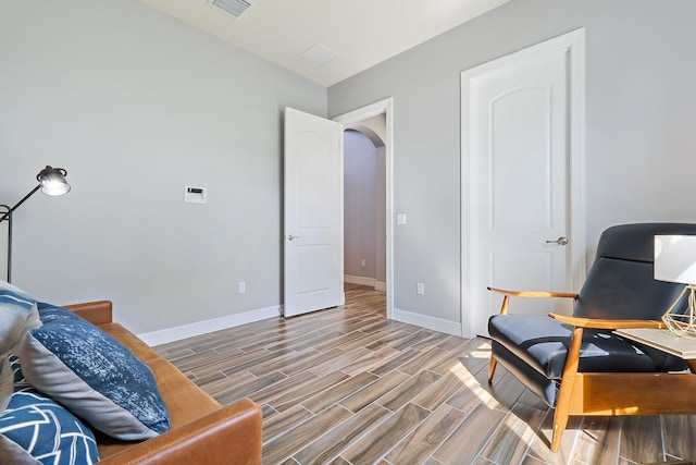 515 Sonoma Isles Cir, Jupiter, FL 33478 - sitting room with baseboards, wood finished floors, and arched walkways