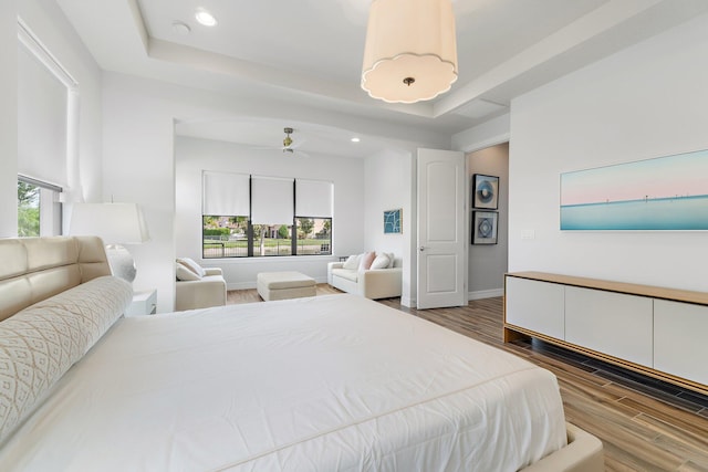 515 Sonoma Isles Cir, Jupiter, FL 33478 - bedroom with wood finished floors, multiple windows, a raised ceiling, recessed lighting, and baseboards