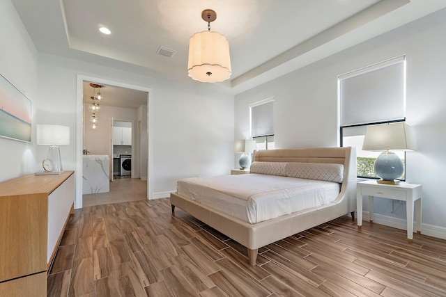 515 Sonoma Isles Cir, Jupiter, FL 33478 - bedroom featuring a tray ceiling, wood finish floors, baseboards, and recessed lighting