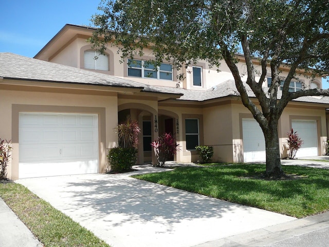 1840 E Sanderling Ln Unit 1, Fort Pierce, FL 34982 - view of front of home featuring stucco siding, driveway, and a garage