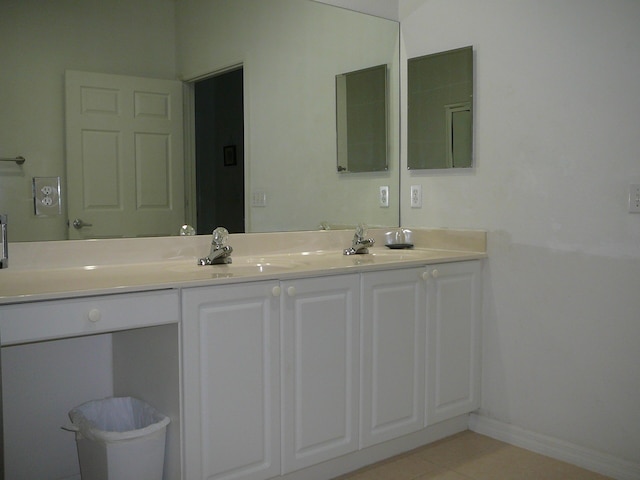 1840 E Sanderling Ln Unit 1, Fort Pierce, FL 34982 - bathroom with double vanity, tile patterned floors, and baseboards