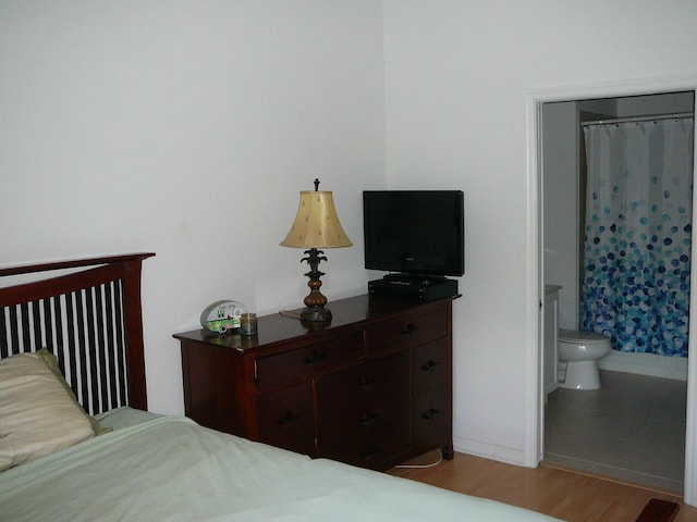 1840 E Sanderling Ln Unit 1, Fort Pierce, FL 34982 - bedroom featuring light wood finished floors, baseboards, and connected bathroom