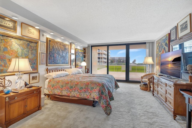 3300 S Ocean Blvd Unit 103S, Palm Beach, FL 33480 - bedroom featuring access to outside, carpet floors, a textured ceiling, and a wall of windows