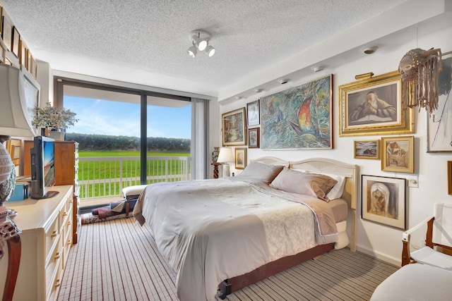 3300 S Ocean Blvd Unit 103S, Palm Beach, FL 33480 - bedroom featuring carpet, a textured ceiling, access to exterior, and baseboards