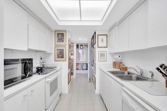 3300 S Ocean Blvd Unit 103S, Palm Beach, FL 33480 - kitchen featuring white appliances, a sink, light tile patterned floors, white cabinets, and light countertops
