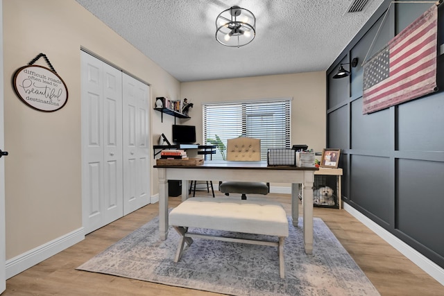 23283 Boca Trace Dr, Boca Raton, FL 33433 - office area featuring a textured ceiling, light wood-style flooring, and baseboards