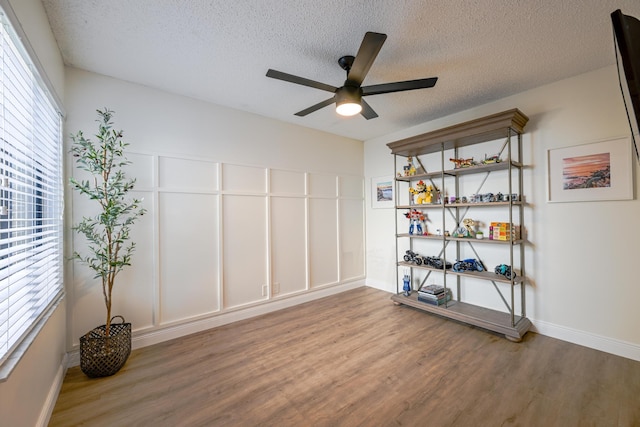 23283 Boca Trace Dr, Boca Raton, FL 33433 - empty room featuring wood finished floors, ceiling fan, a textured ceiling, and baseboards