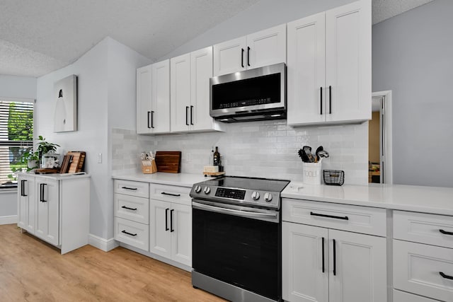 23283 Boca Trace Dr, Boca Raton, FL 33433 - kitchen with stainless steel appliances, a textured ceiling, light countertops, tasteful backsplash, and light wood-type flooring