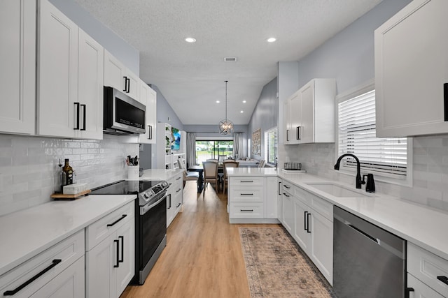 23283 Boca Trace Dr, Boca Raton, FL 33433 - kitchen with stainless steel appliances, a sink, light countertops, recessed lighting, and tasteful backsplash