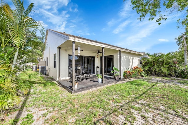 23283 Boca Trace Dr, Boca Raton, FL 33433 - rear view of house with a ceiling fan, stucco siding, a patio area, central air condition unit, and a lawn