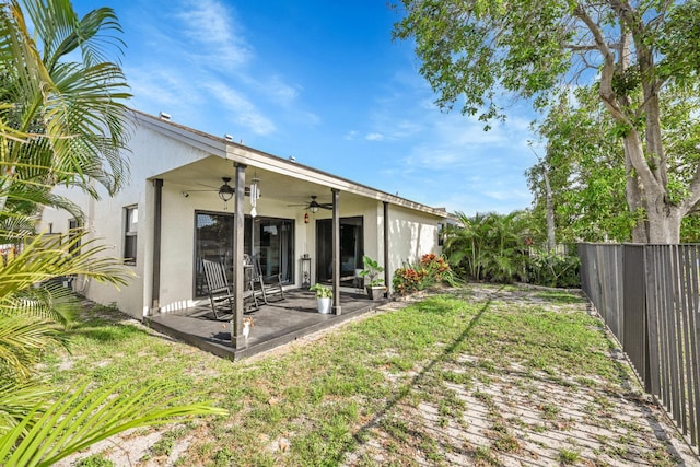 23283 Boca Trace Dr, Boca Raton, FL 33433 - rear view of property with ceiling fan, a fenced backyard, stucco siding, and a patio