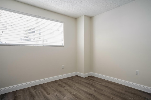 1673 Bay Rd Unit 206, Miami Beach, FL 33139 - spare room with dark wood-type flooring, a textured ceiling, and baseboards