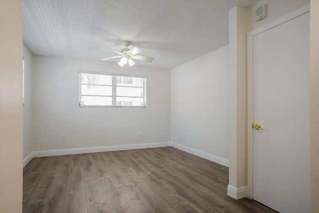 1673 Bay Rd Unit 206, Miami Beach, FL 33139 - spare room featuring ceiling fan, a textured ceiling, wood finished floors, and baseboards