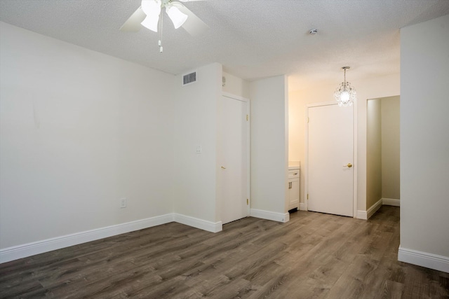 1673 Bay Rd Unit 206, Miami Beach, FL 33139 - unfurnished room featuring wood finished floors, ceiling fan, baseboards, and a chandelier