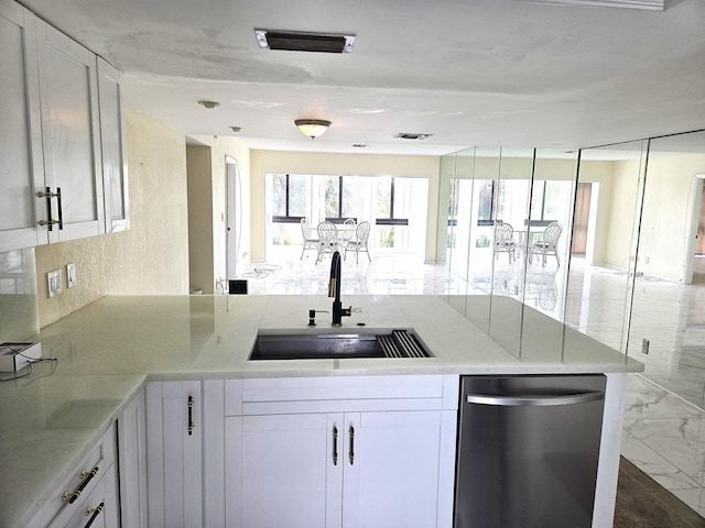 1731 Presidential Way Unit C201, West Palm Beach, FL 33401 - kitchen with dishwasher, white cabinetry, a peninsula, light stone countertops, and marble finish floors