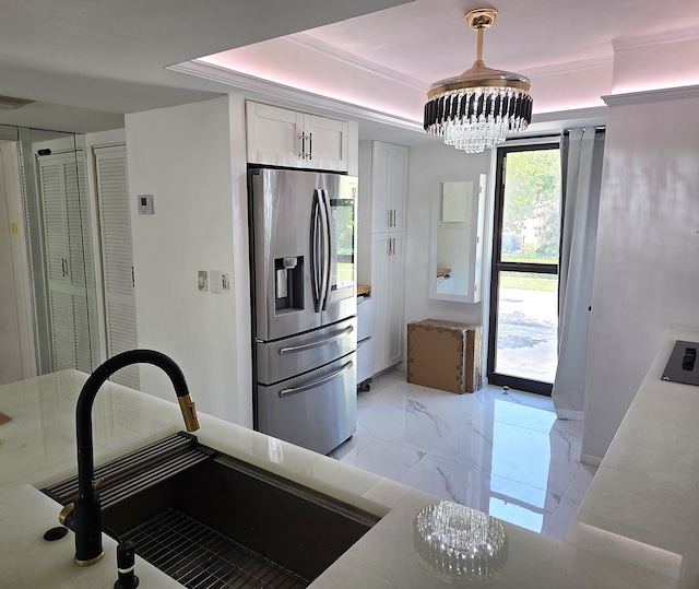 1731 Presidential Way Unit C201, West Palm Beach, FL 33401 - kitchen featuring stainless steel fridge with ice dispenser, a chandelier, light marble finish flooring, white cabinets, and a raised ceiling