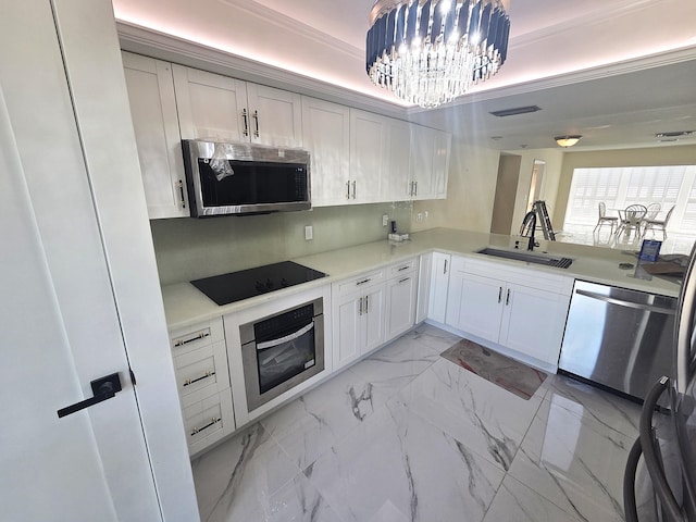 1731 Presidential Way Unit C201, West Palm Beach, FL 33401 - kitchen with stainless steel appliances, light marble finish floors, a chandelier, light countertops, and white cabinetry