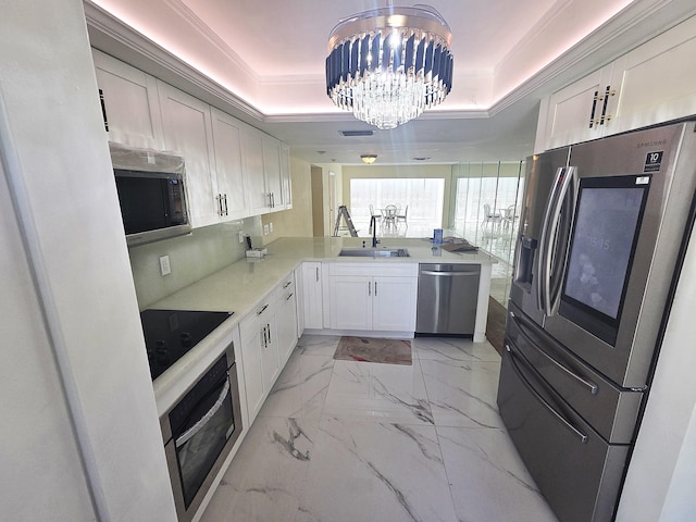 1731 Presidential Way Unit C201, West Palm Beach, FL 33401 - kitchen featuring stainless steel appliances, a raised ceiling, a peninsula, light marble finish floors, and crown molding
