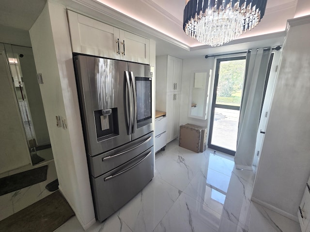 1731 Presidential Way Unit C201, West Palm Beach, FL 33401 - kitchen with stainless steel fridge, light marble finish flooring, white cabinets, a chandelier, and radiator