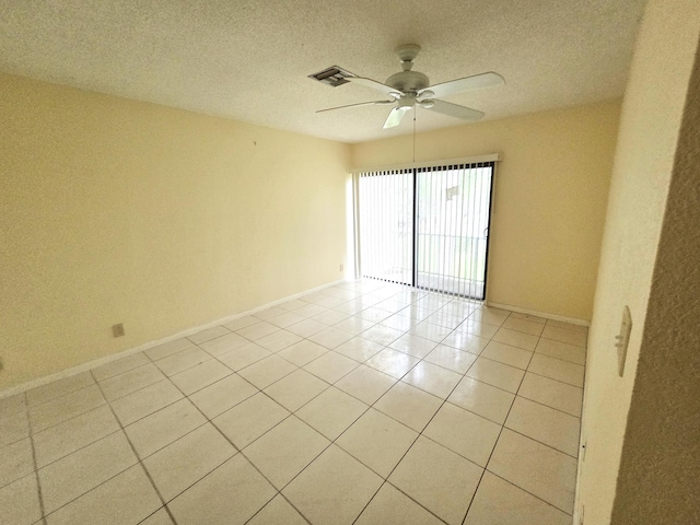 1731 Presidential Way Unit C201, West Palm Beach, FL 33401 - unfurnished room featuring ceiling fan, light tile patterned flooring, and a textured ceiling