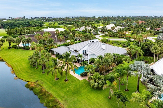2150 SE Golfview Ln, Stuart, FL 34996 - drone / aerial view of a nearby body of water, a pool area, and a tree filled landscape