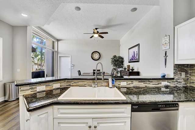 17233 Bermuda Village Dr, Boca Raton, FL 33487 - kitchen with stainless steel dishwasher, a textured ceiling, a ceiling fan, a sink, and decorative backsplash