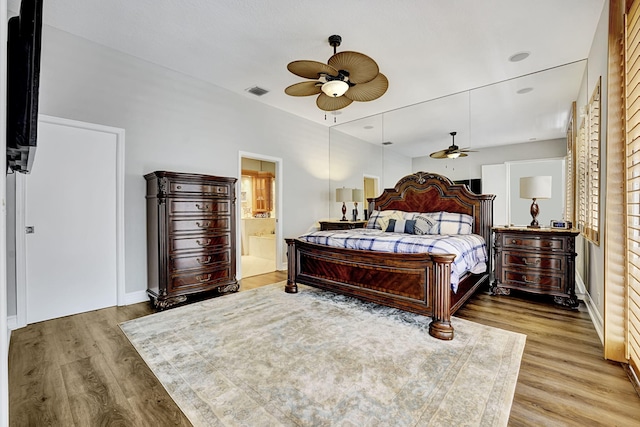 17233 Bermuda Village Dr, Boca Raton, FL 33487 - bedroom with light wood finished floors, baseboards, connected bathroom, and a ceiling fan