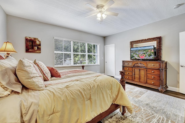 17233 Bermuda Village Dr, Boca Raton, FL 33487 - bedroom with wood finished floors, a textured ceiling, baseboards, and a ceiling fan