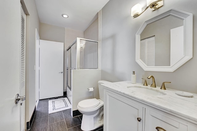 17233 Bermuda Village Dr, Boca Raton, FL 33487 - bathroom with vanity, toilet, combined bath / shower with glass door, a closet, and baseboards