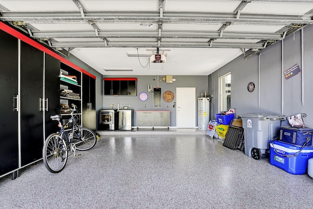 17233 Bermuda Village Dr, Boca Raton, FL 33487 - garage featuring washing machine and clothes dryer, electric water heater, and a garage door opener