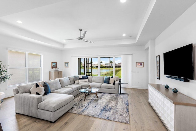 13487 Whistler Mountain Rd, Delray Beach, FL 33446 - living area featuring a raised ceiling, a ceiling fan, recessed lighting, light wood-style floors, and baseboards