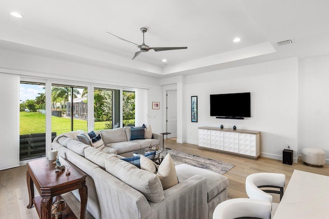 13487 Whistler Mountain Rd, Delray Beach, FL 33446 - living room featuring a tray ceiling, a ceiling fan, recessed lighting, light wood-style floors, and baseboards