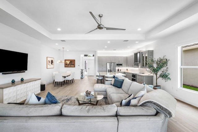 13487 Whistler Mountain Rd, Delray Beach, FL 33446 - living area with light wood-style flooring, baseboards, recessed lighting, a ceiling fan, and a raised ceiling
