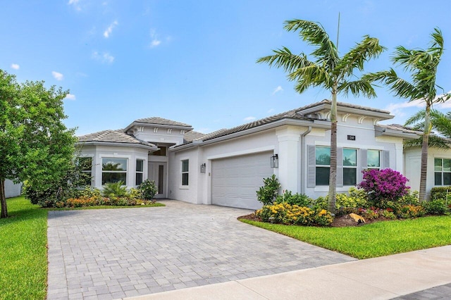 13487 Whistler Mountain Rd, Delray Beach, FL 33446 - view of front of home featuring a garage, stucco siding, decorative driveway, and a tiled roof