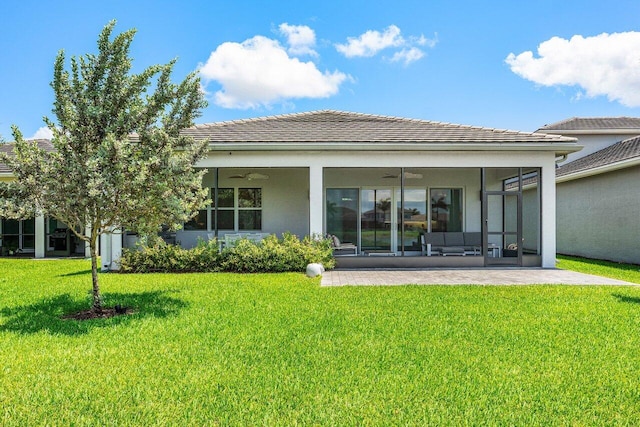 13487 Whistler Mountain Rd, Delray Beach, FL 33446 - back of house with a ceiling fan, a sunroom, a yard, stucco siding, and a tiled roof