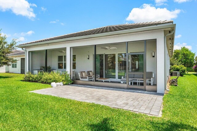 13487 Whistler Mountain Rd, Delray Beach, FL 33446 - rear view of house with a sunroom, a ceiling fan, a yard, and a patio area