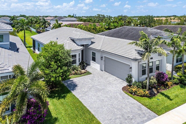 13487 Whistler Mountain Rd, Delray Beach, FL 33446 - view of front of home with an attached garage, driveway, and stucco siding